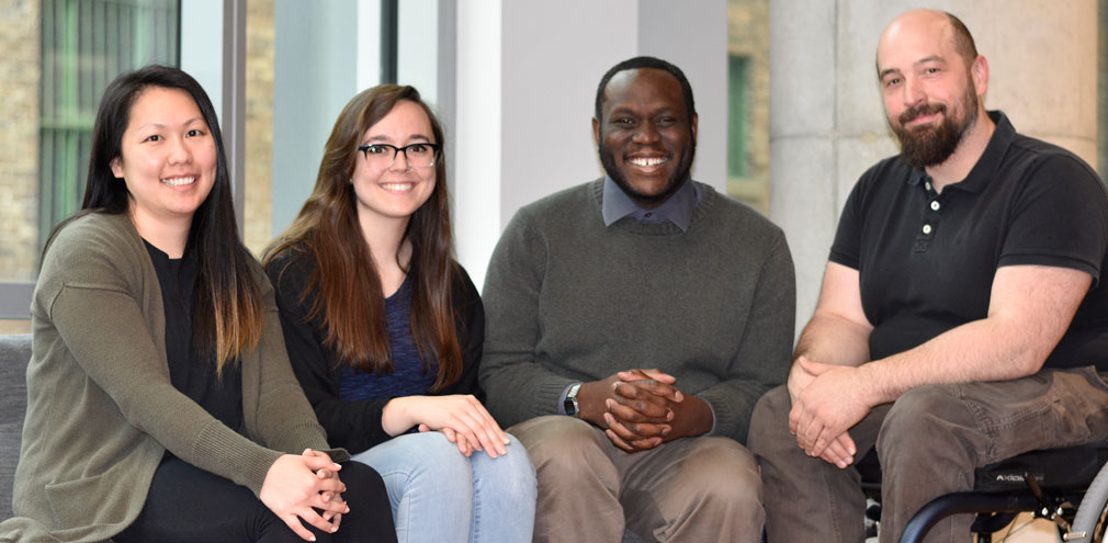 Four members of the IHC Team sitting together, smiling at the camera